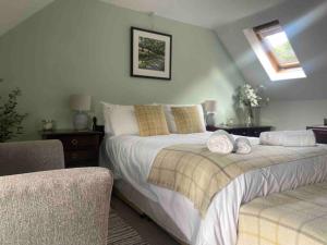 a bedroom with a bed with two towels on it at Scenic Couples Getaway in the Brecon Beacons in Crickhowell