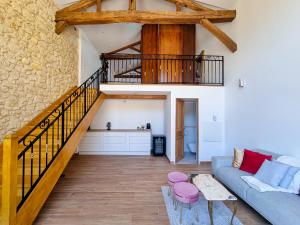 a living room with a couch and a staircase at Chateau Erigoye in Beychac-et-Caillau