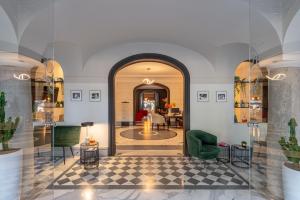 a room with a lobby with a table and chairs at Hotel Principe Torlonia in Rome