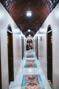 a hallway with a tile floor in a building at Tuya Hotel in Abu Simbel