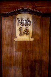 a wooden door with the number on it at Tuya Hotel in Abu Simbel