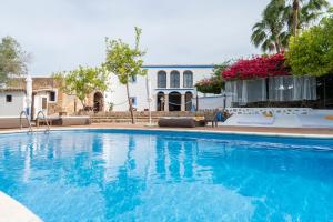 a large blue swimming pool in front of a house at Agroturismo Can Marquet - Adults Only in Santa Gertrudis de Fruitera +34 photos