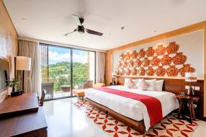 a bedroom with a large bed and a large window at Salinda Resort Phu Quoc - Sparkling Wine Breakfast in Phú Quốc