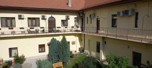 an apartment building with a tree in the courtyard at LUNA in Oradea