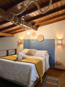 a bedroom with a large bed in a room with wooden ceilings at Kanaloa Vibe Stay in Praia do Rosa