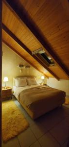 アラコバにあるThe Wooden Nest Arachovaのベッドルーム1室(屋根裏部屋に大型ベッド1台付)
