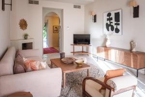 a living room with a couch and a table at Domaine Des Remparts Hotel & Spa in Marrakech