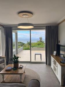 a living room with a view of the beach at Bayview 104 in Hermanus