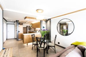 a dining room and kitchen with a table and a mirror at Bayview 104 in Hermanus