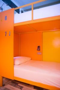two bunk beds in an orange room at City Hostel Shymkent in Shymkent