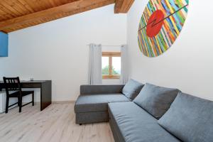 a living room with a couch and a table at Hotel New Genziana in Altavilla Vicentina