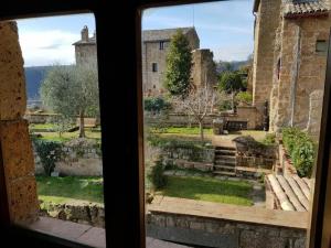 a view of a garden from a window at il sogno di Civita in Bagnoregio