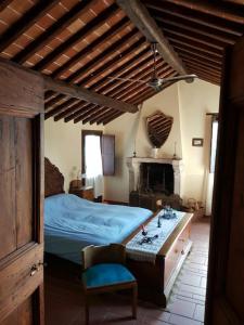 a bedroom with a bed and a table and a fireplace at il sogno di Civita in Bagnoregio