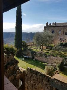a view of a castle with a stone wall at il sogno di Civita in Bagnoregio