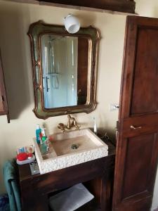 a bathroom with a sink and a mirror at il sogno di Civita in Bagnoregio