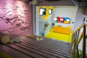 a kids room with a staircase and a wall with a mural at City Hostel Shymkent in Shymkent
