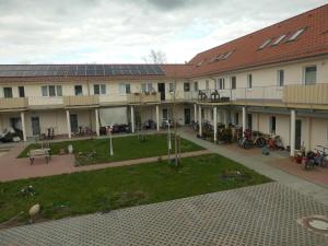 a courtyard of a building with solar panels on it at Top 2-Zimmerwohnung mit Balkon in Ludwigsfelde