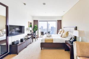 Address Marina Mall Suites "Full Marina Views & Balcony " في دبي: غرفه فندقيه سرير وتلفزيون