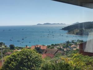 a view of a harbor with boats in the water at Apartamento mirador a las Islas Cíes in Cangas de Morrazo