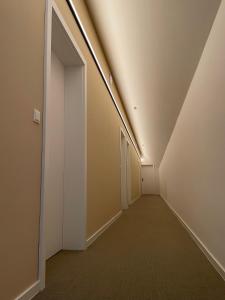 an empty hallway with a light on the ceiling at Haus Karlich in Trausdorf an der Wulka +32 photos