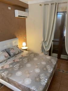 a bedroom with a large bed and a window at Vendicari in Pachino