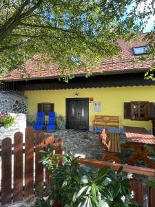 een geel huis met een patio ervoor bij Boutique Tourist Farm Hrovat in Frankolovo