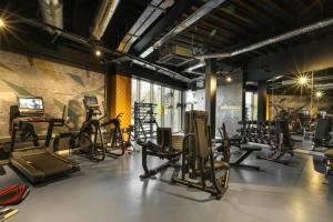 a gym with a bunch of exercise equipment in a room at Manchester Townhouses by Charles Hope in Manchester