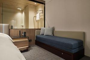 a bedroom with a bed and a large mirror at K Hotel Taipei Nanjing in Taipei