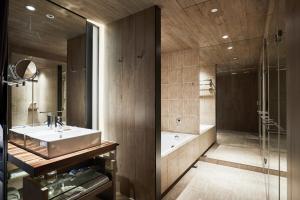 a bathroom with a sink and a shower at K Hotel Taipei Nanjing in Taipei