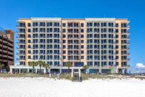 a large building on the beach with a beach at Hampton Inn & Suites - Orange Beach in Orange Beach