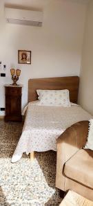 a bedroom with a bed and a couch at Casa Pancrazia in Taormina