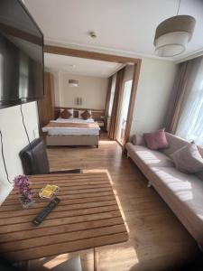 a living room with a couch and a bed at Aycan Sultan Apart Hotel in Istanbul