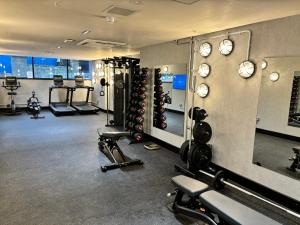 a fitness room with a bunch of equipment and mirrors at Sandman Signature Glasgow Hotel in Glasgow