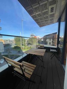 a balcony with a table and chairs and a large window at 2 Bedrooms Apartment In RG Centre in Reading