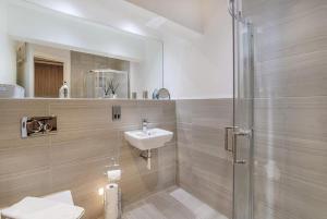 a bathroom with a sink and a shower at The Garden Room in York