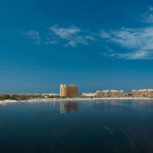 a large body of water with a city in the background at DoubleTree by Hilton Resort & Spa Marjan Island in Ras al Khaimah