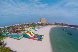 an aerial view of a beach with a water park at DoubleTree by Hilton Resort & Spa Marjan Island in Ras al Khaimah