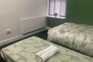a bedroom with a bed and a bedskirts at One2One - Duplex Relocations in Wakefield