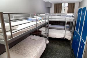a small room with two bunk beds in it at Alberg Sants Bcn in Barcelona