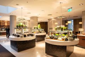 a restaurant with two counters with food on display at Tallink Hotel Riga in Rīga