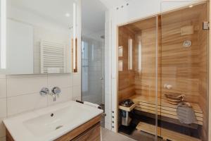 a bathroom with a shower and a white sink at SandKorn 1 und 2 in Pruchten