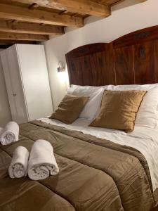 a bedroom with a large bed with towels on it at La casa della Francesca * * * * * in Florence