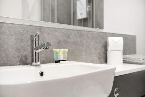 a white sink in a bathroom with a mirror at Modern Apartments in the Heart of Middlesbrough 2 in Middlesbrough