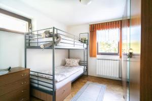 a bedroom with two bunk beds and a window at Apartment Satya in Dobrna