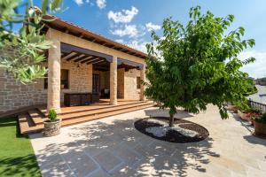 Casa Rural Alvaro في Albares: منزل به شجرة على الفناء