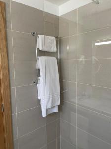 a bathroom with a shower with white towels at INATEL Oeiras in Oeiras +44 photos