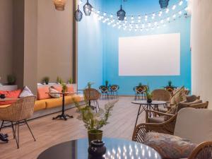 a living room with a couch and a table and chairs at Ibis Abdelmoumen Casa Centre in Casablanca