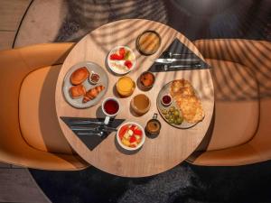 a wooden table with food on top of it at Ibis Paris Gare Montparnasse Catalogne in Paris