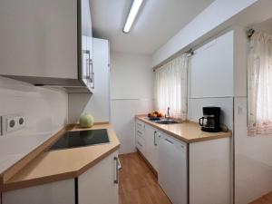 a kitchen with white cabinets and a counter top at Summerlandrota Cordoba8 in Rota +13 photos