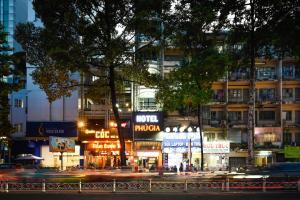 a busy city street at night with buildings at Phu Gia Hotel 193 Nguyen Thai Hoc in Ho Chi Minh City